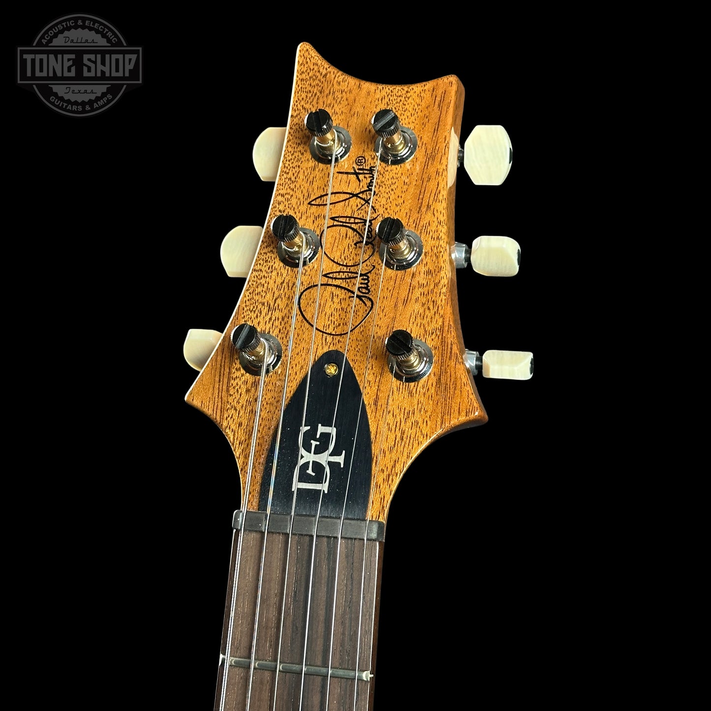 Guitar headstock with brand logo on a black background