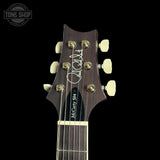 Guitar headstock with brand logo on a black background
