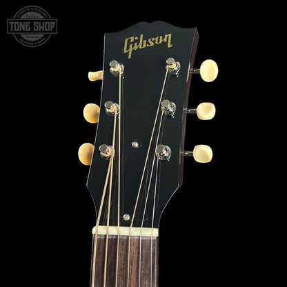 Gibson guitar headstock with brand name on a black background
