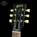 Gibson Les Paul guitar headstock with brand name on a black background
