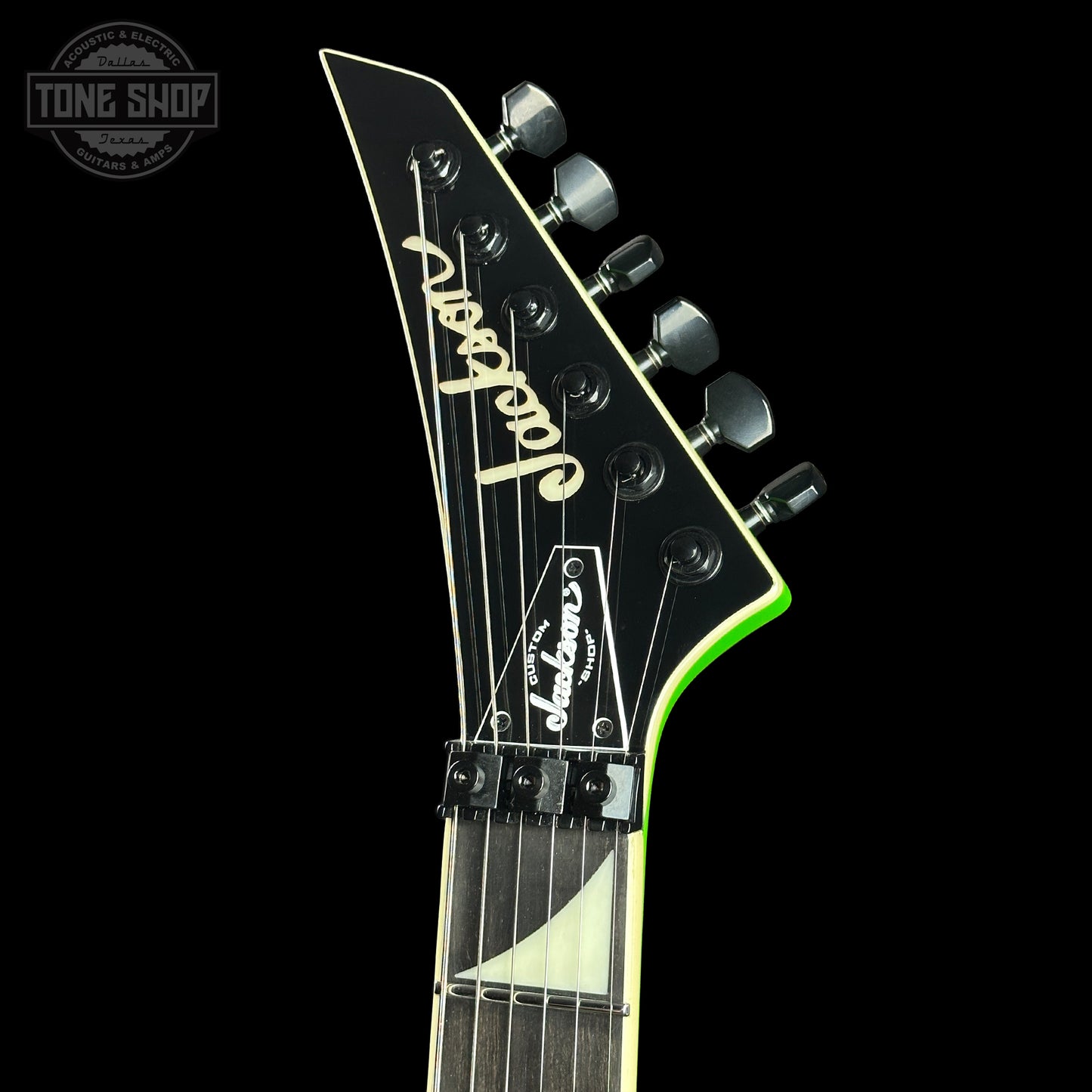 Guitar headstock with 'Jackson' branding on a black background