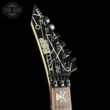 Guitar headstock with brand logo on a black background