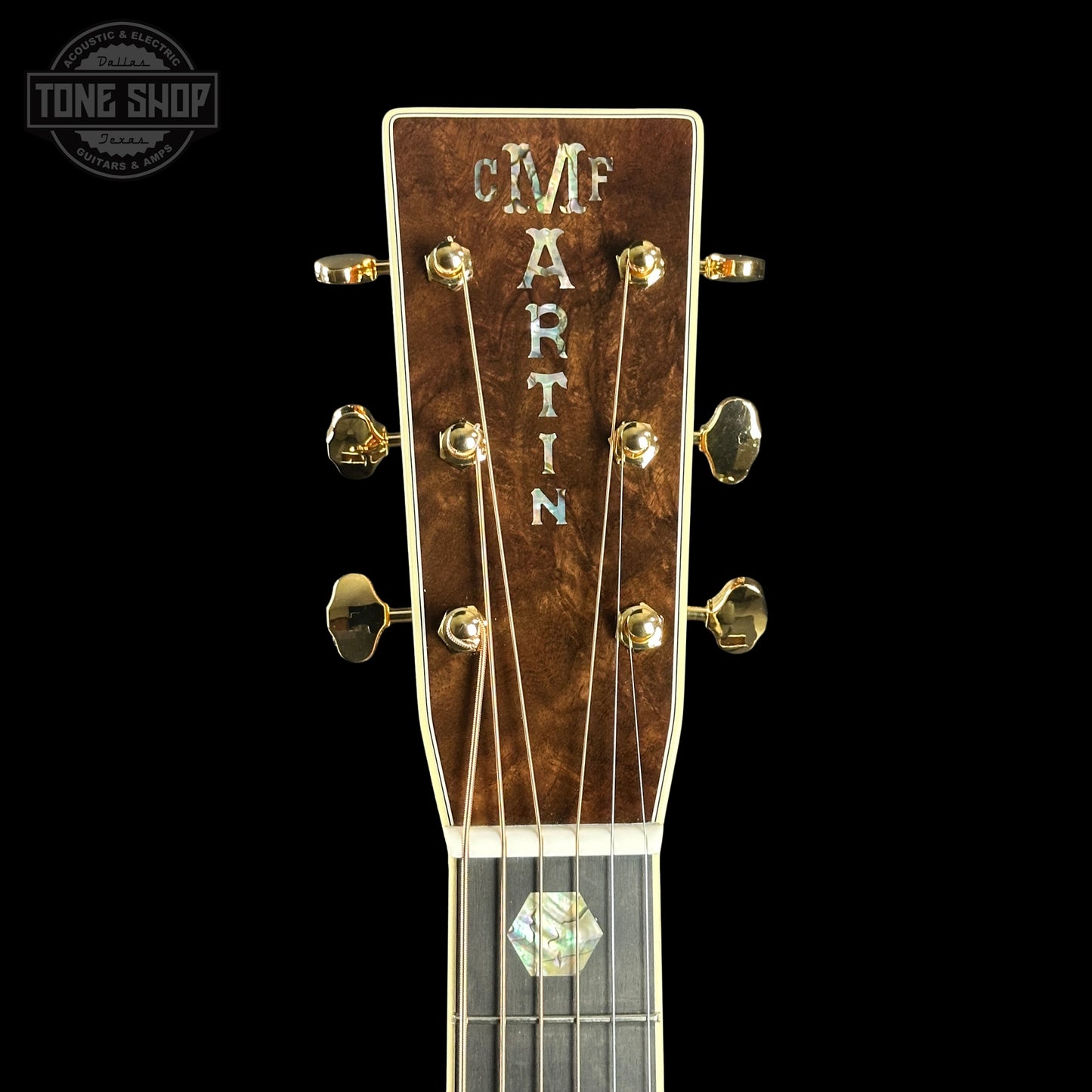 Close-up of a Martin guitar headstock with 'Tone Shop' logo in the corner.