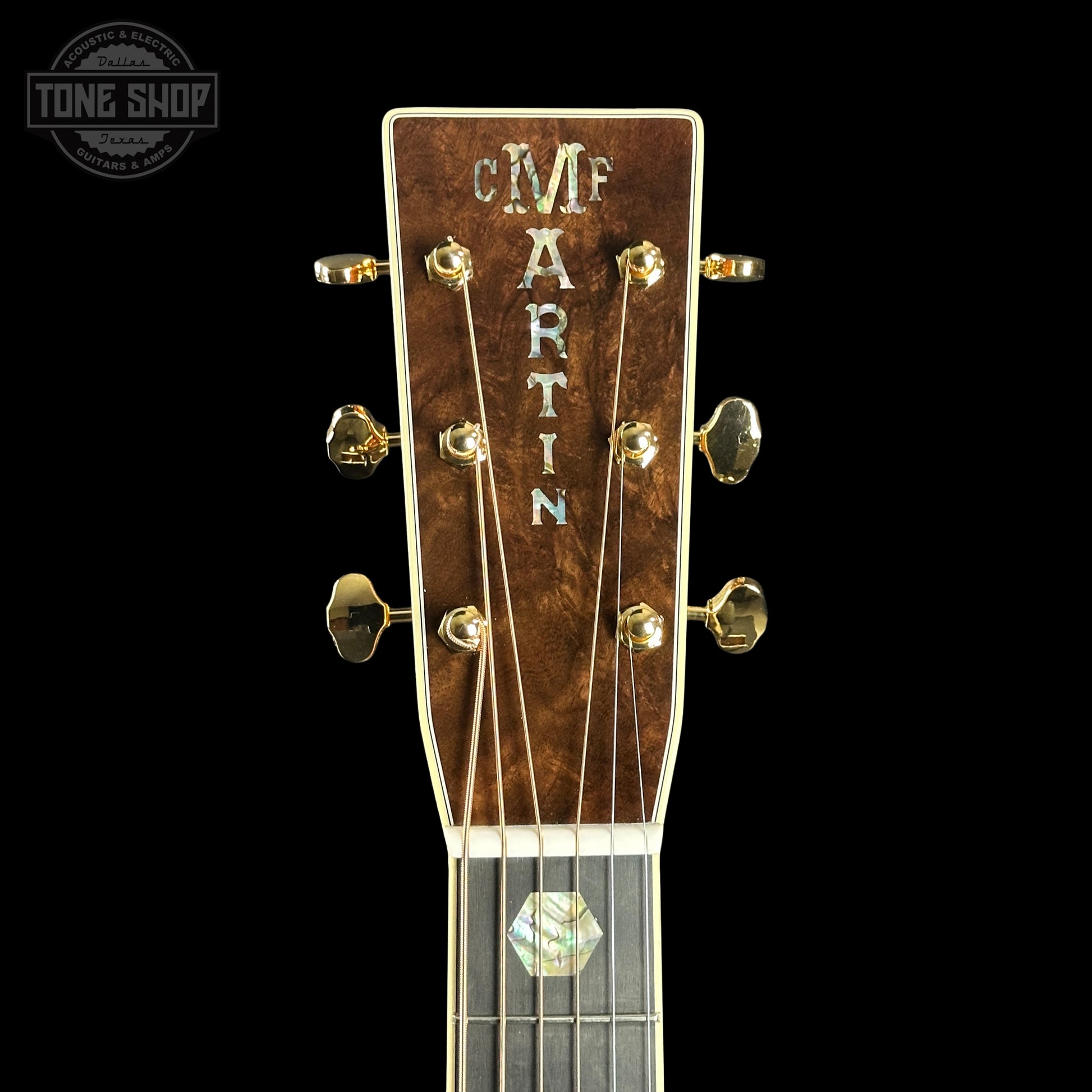 Close-up of a Martin guitar headstock with 'Tone Shop' logo in the corner.
