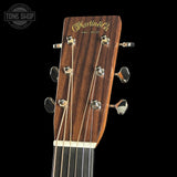 Close-up of a Martin guitar headstock with brand name on a black background
