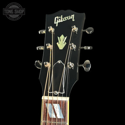 Gibson guitar headstock with brand logo on a black background