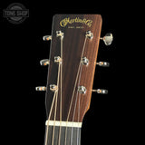 Guitar headstock with Martin & Co logo on a black background