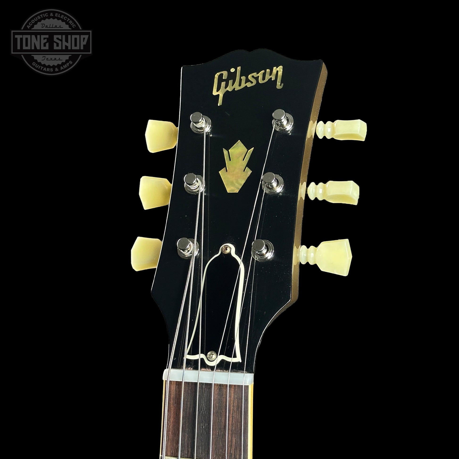 Gibson guitar headstock with brand logo on a black background