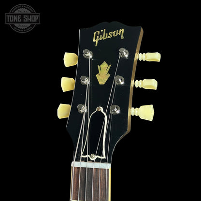 Gibson guitar headstock with brand logo on a black background