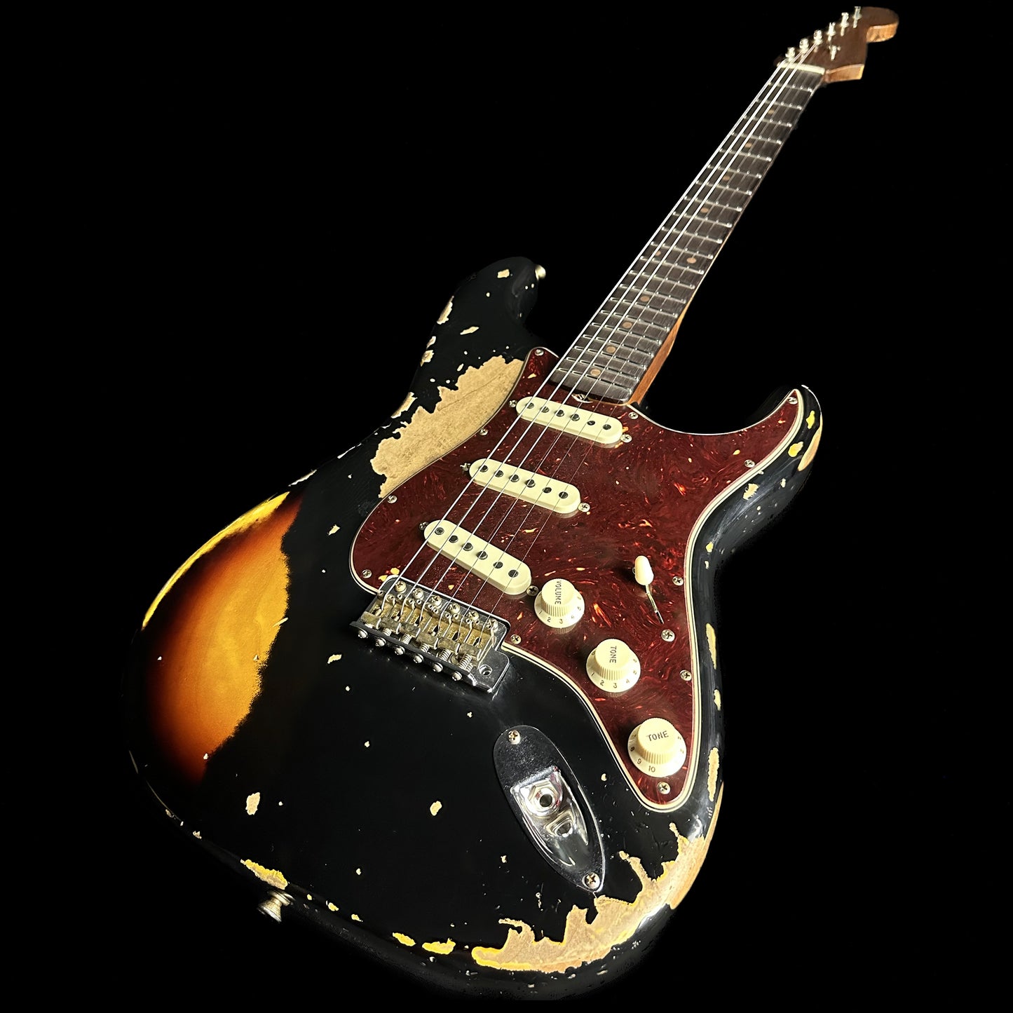 Front angle of Fender Custom Shop Limited Edition Roasted '61 Strat - Super Heavy Relic Aged Black over 3-color Sunburst.