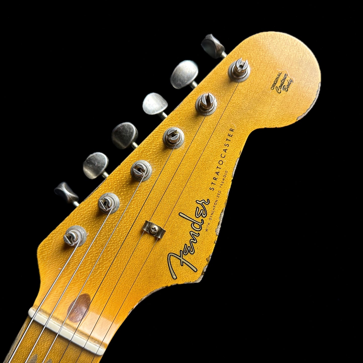 Closeup of Fender Custom Shop 58 Strat Relic Faded Aged Chocolate 3-color Sunburst headstock.