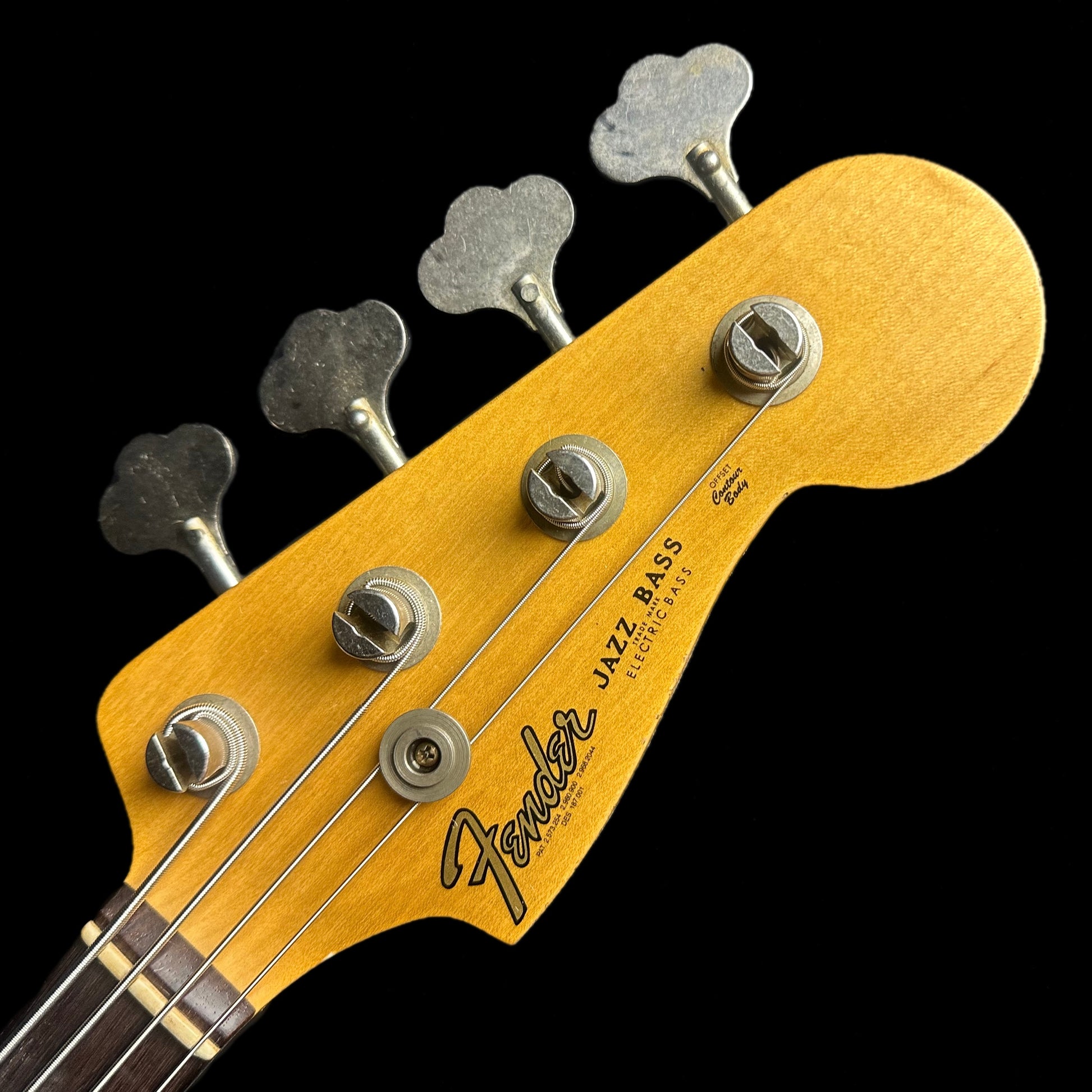 Closeup of Fender Custom Shop 1962 Jazz Bass Relic Aged Black headstock.