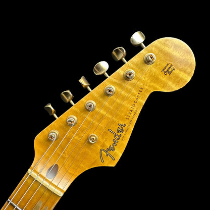 Closeup of Fender Custom Shop Limited Edition '55 "bone-tone" Strat - Relic Wide-Fade 2-color Sunburst headstock.