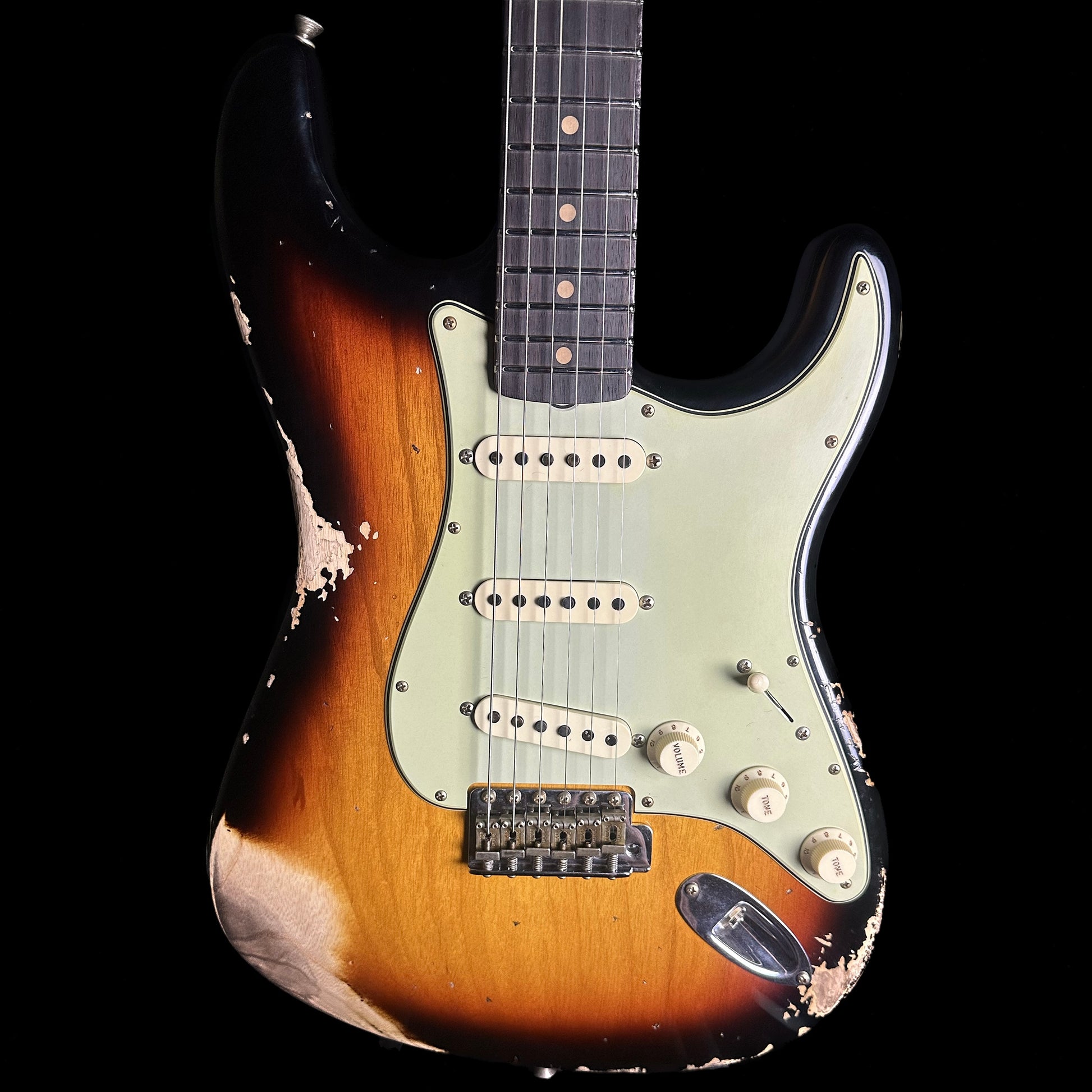 Front of Fender Custom Shop Limited Edition '62 Strat Heavy Relic Faded Aged 3 Color Sunburst.