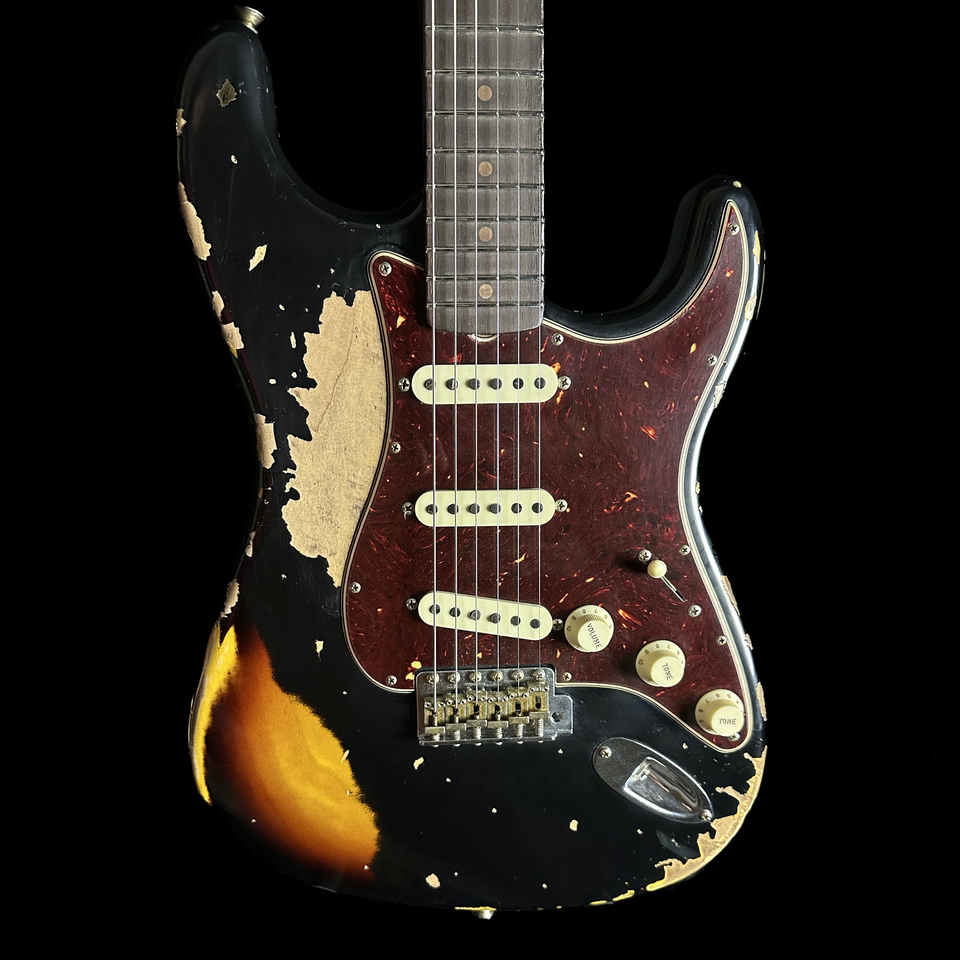 Front of Fender Custom Shop Limited Edition Roasted '61 Strat - Super Heavy Relic Aged Black over 3-color Sunburst.