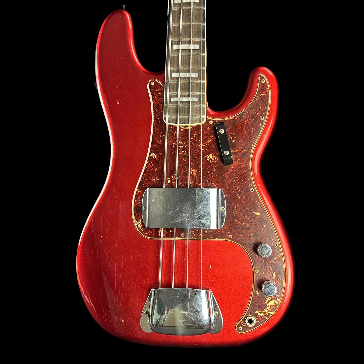Front of Fender Custom Shop Limited P Jazz Bass Journeyman Aged Candy Apple Red.
