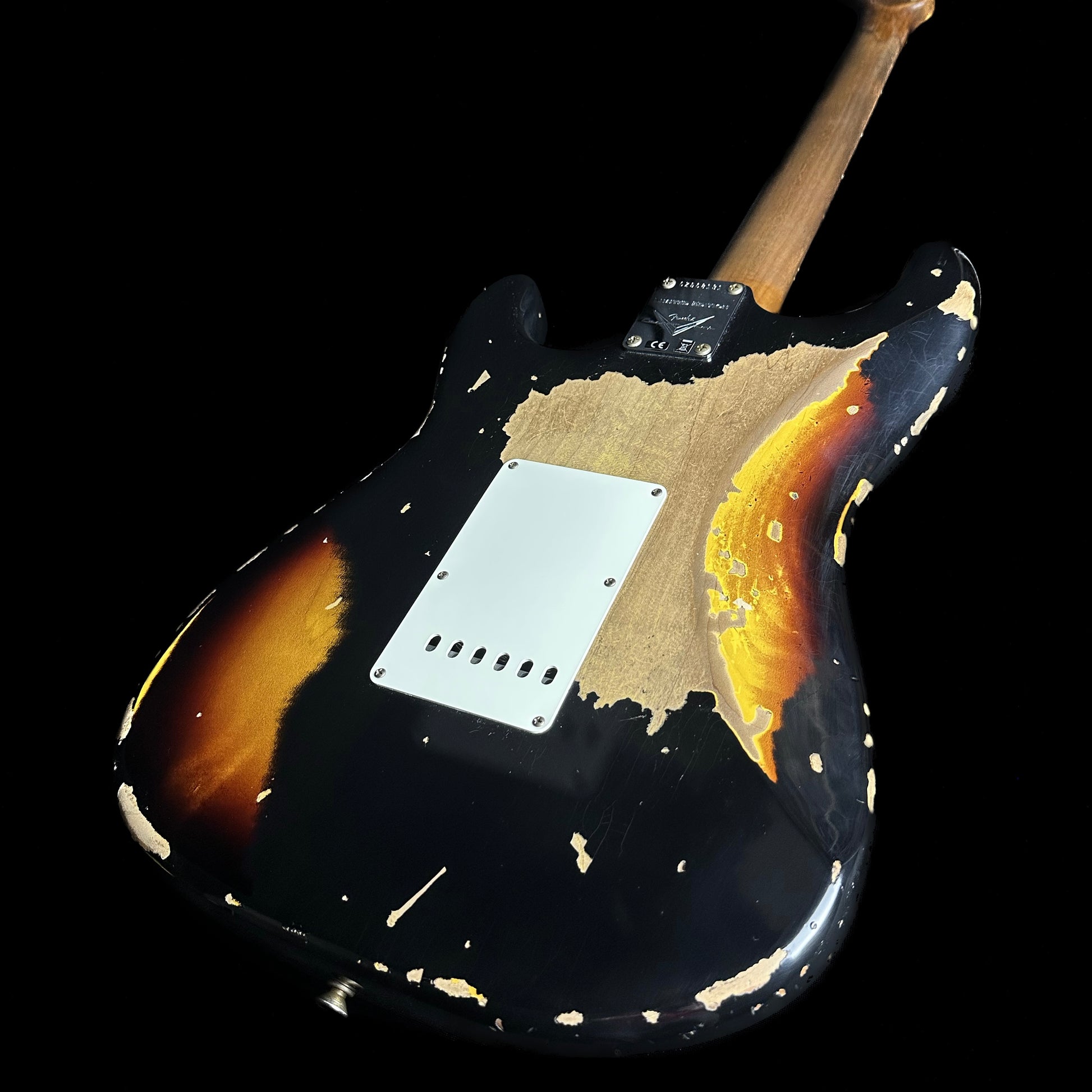 Back angle of Fender Custom Shop Limited Edition Roasted '61 Strat - Super Heavy Relic Aged Black over 3-color Sunburst.