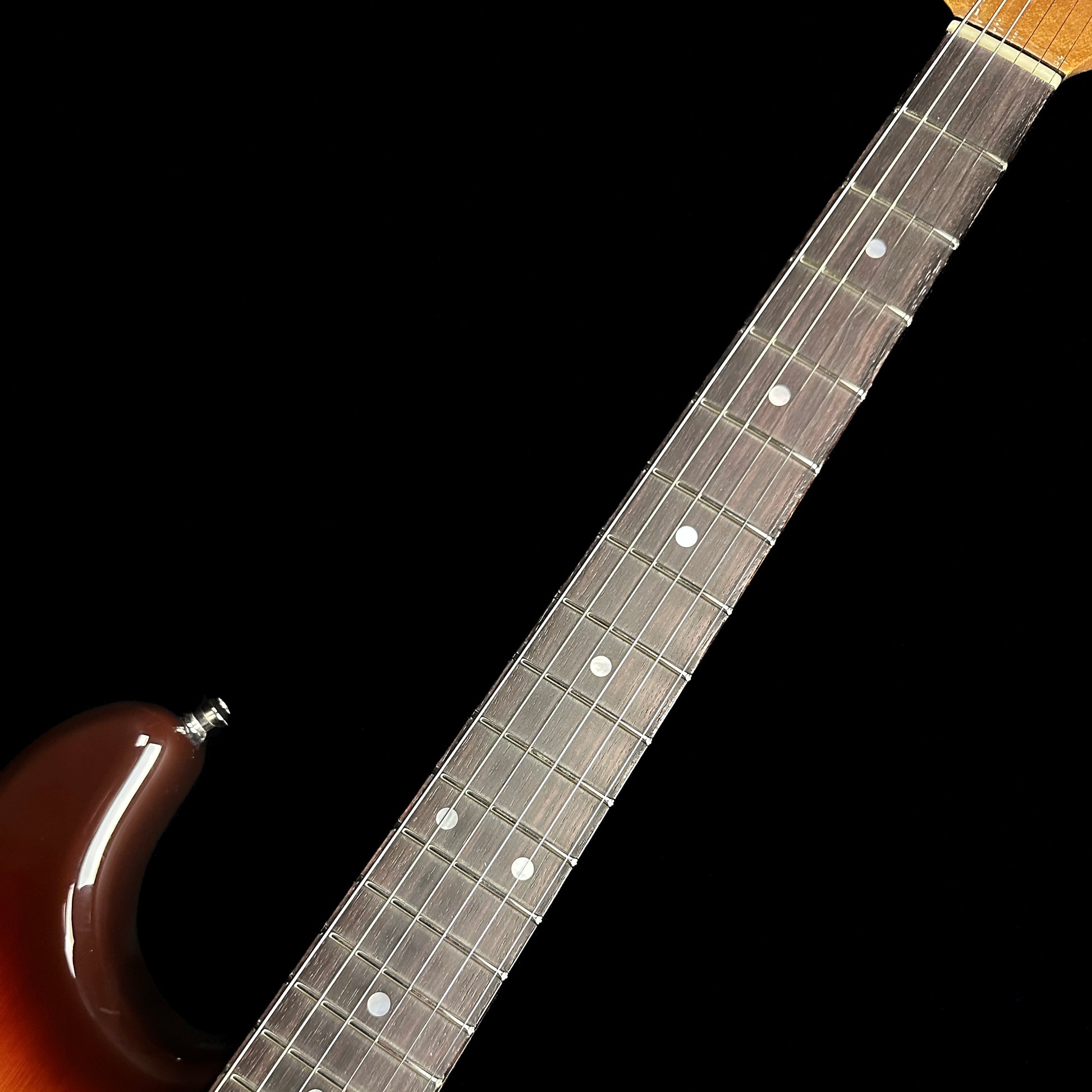 Closeup of Fender Custom Shop American Custom Strat NOS RW Chocolate 3-Color Sunburst fretboard.