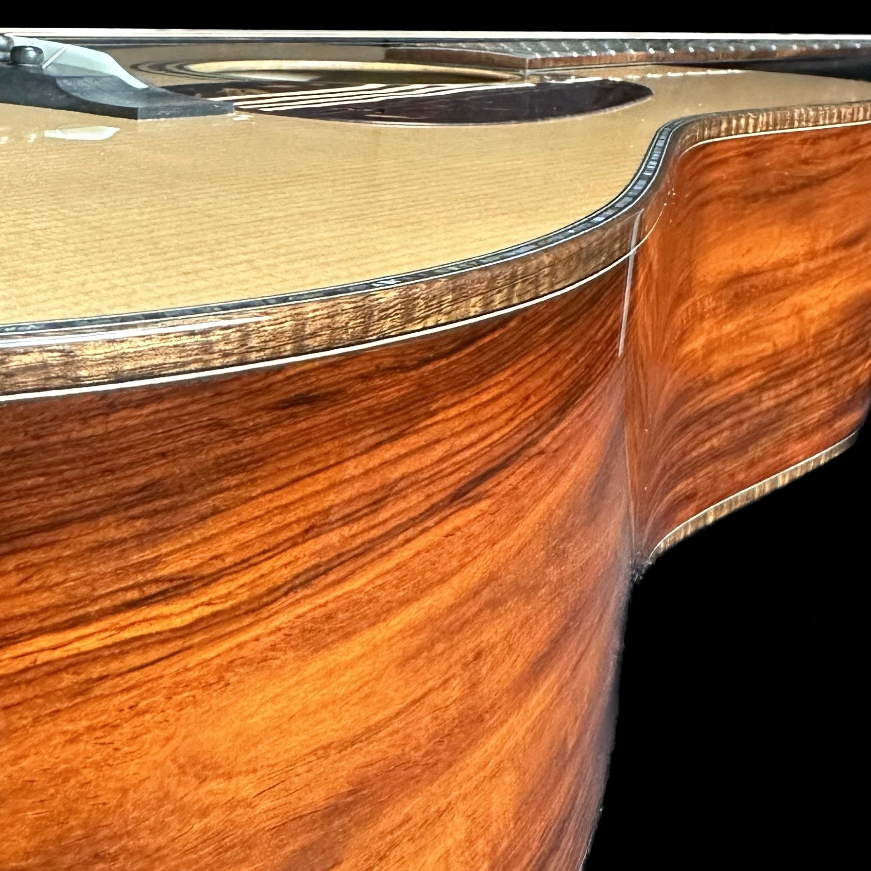 Close up side angle of Huss & Dalton TD-R Custom 42 Style Red Spruce Cocobolo.