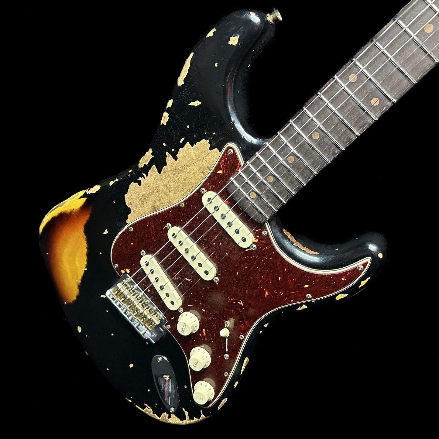 Front angle of Fender Custom Shop Limited Edition Roasted '61 Strat - Super Heavy Relic Aged Black over 3-color Sunburst.