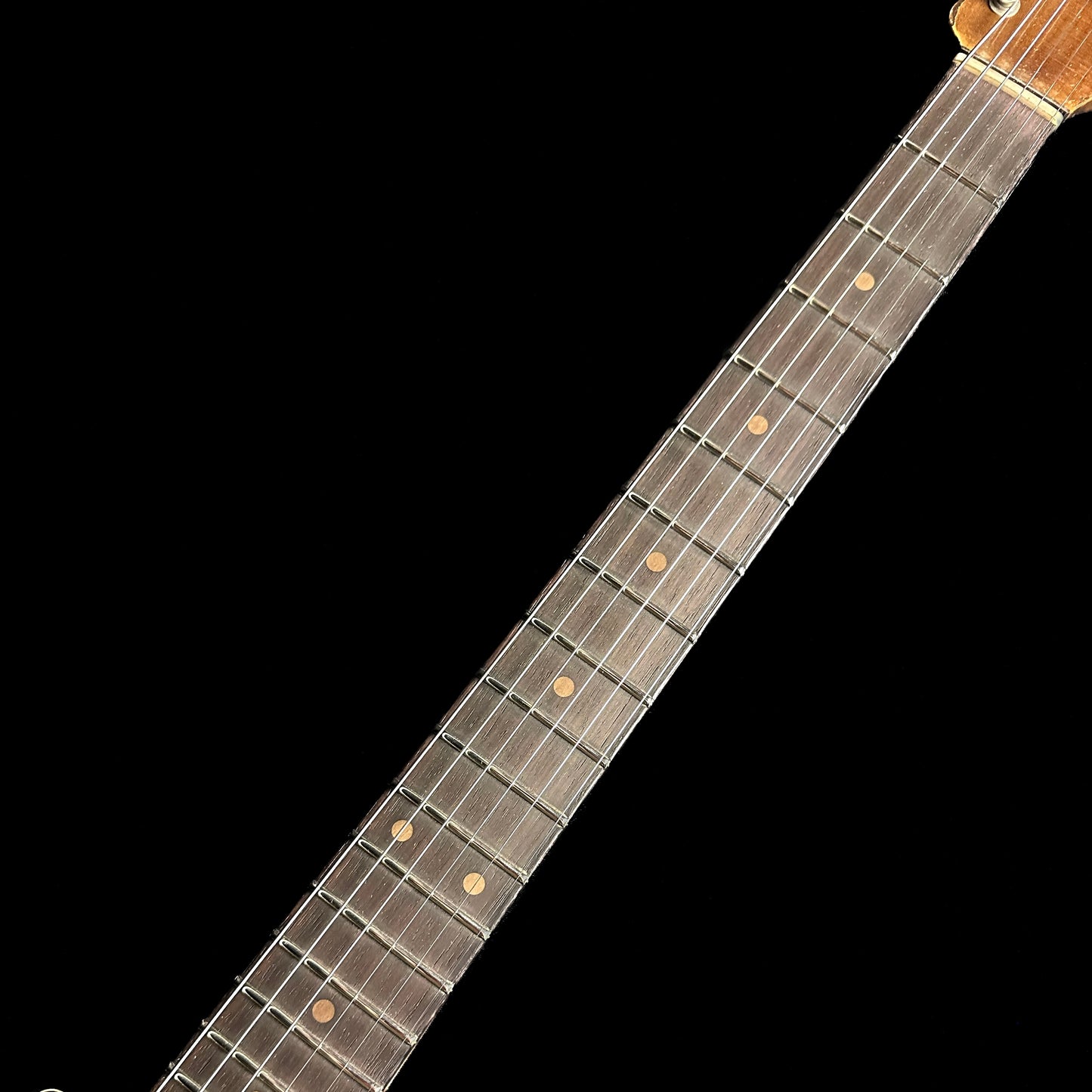 Closeup of Fender Custom Shop Limited Edition Roasted '61 Strat - Super Heavy Relic Aged Black over 3-color Sunburst fretboard.