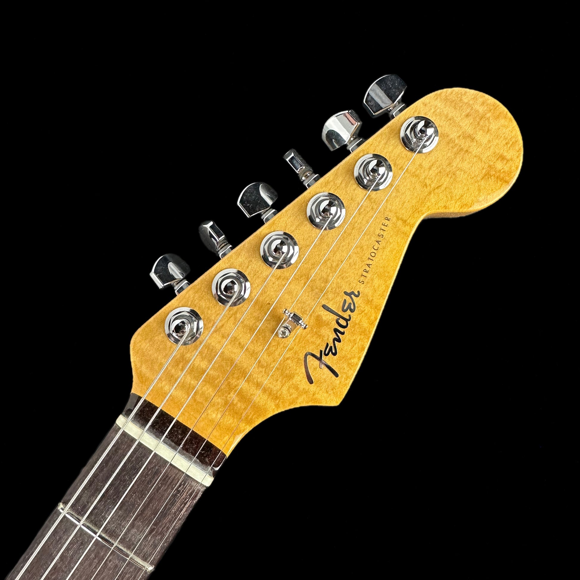 Close up of headstock of Fender Custom Shop American Custom Stratocaster RW Ebony Transparent.