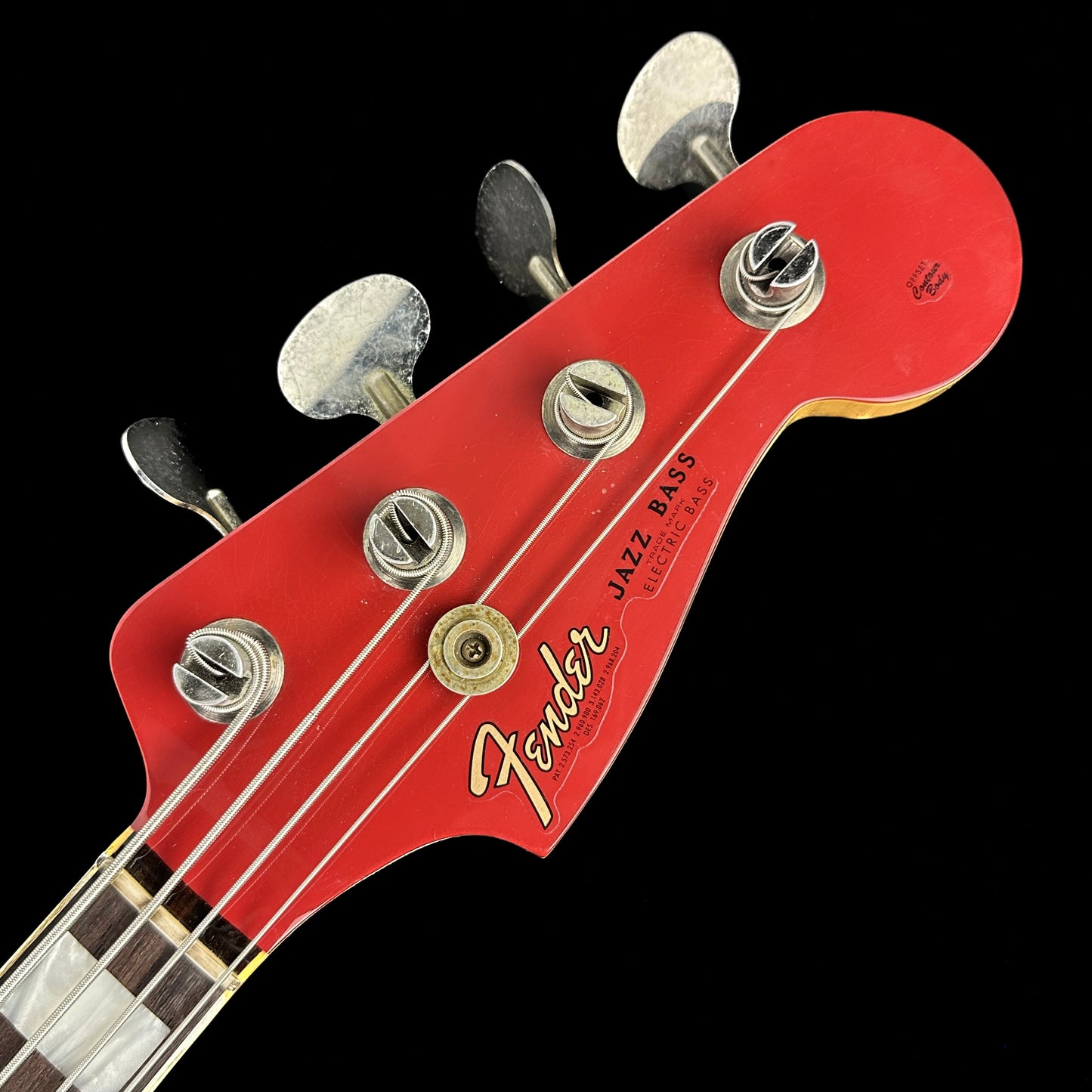 Closeup of Fender Custom Shop Limited Edition P Bass Special Journeyman Relic Aged Dakota Red headstock.