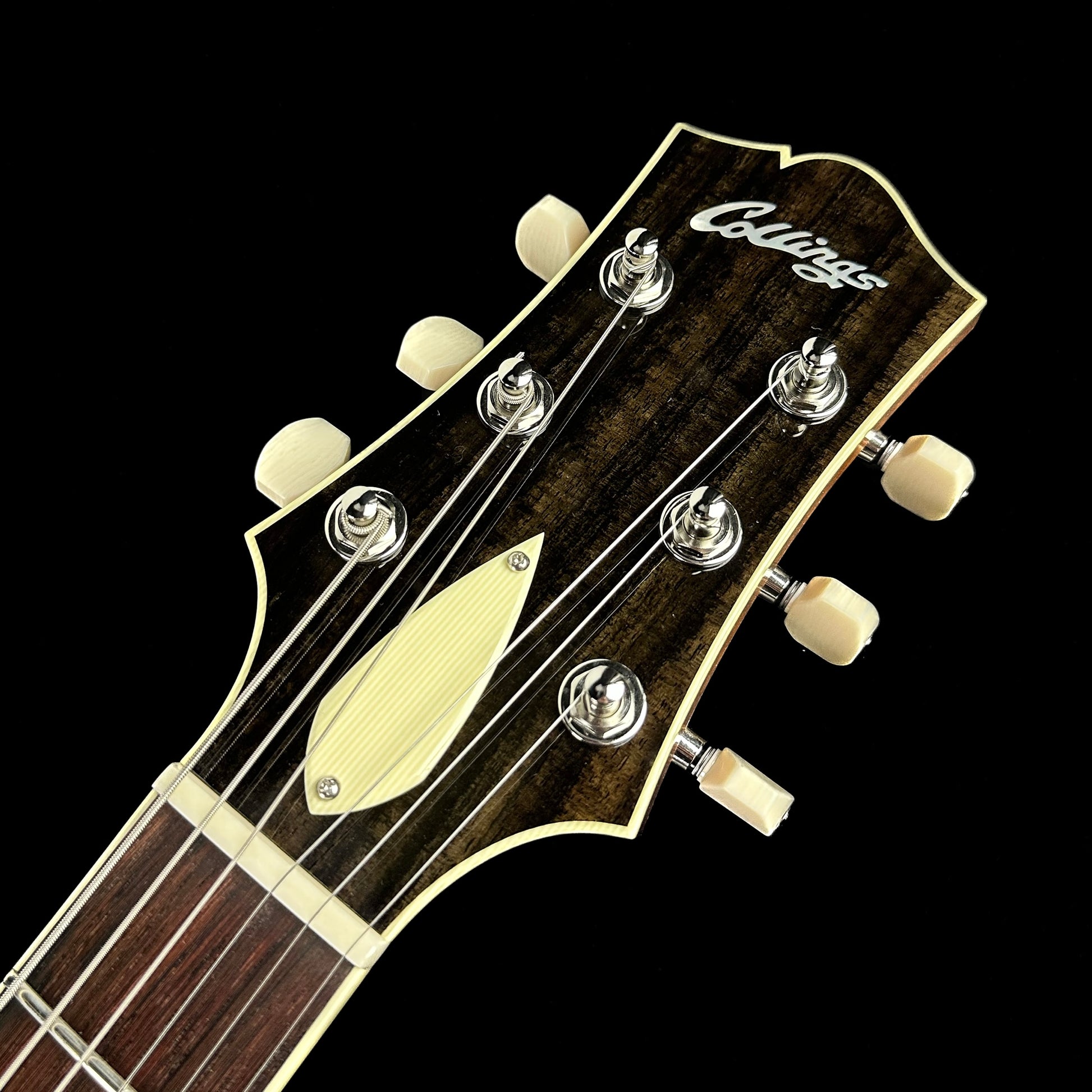 Close up of Collings I-35 Deluxe Blonde Flame Top ThroBaks headstock.
