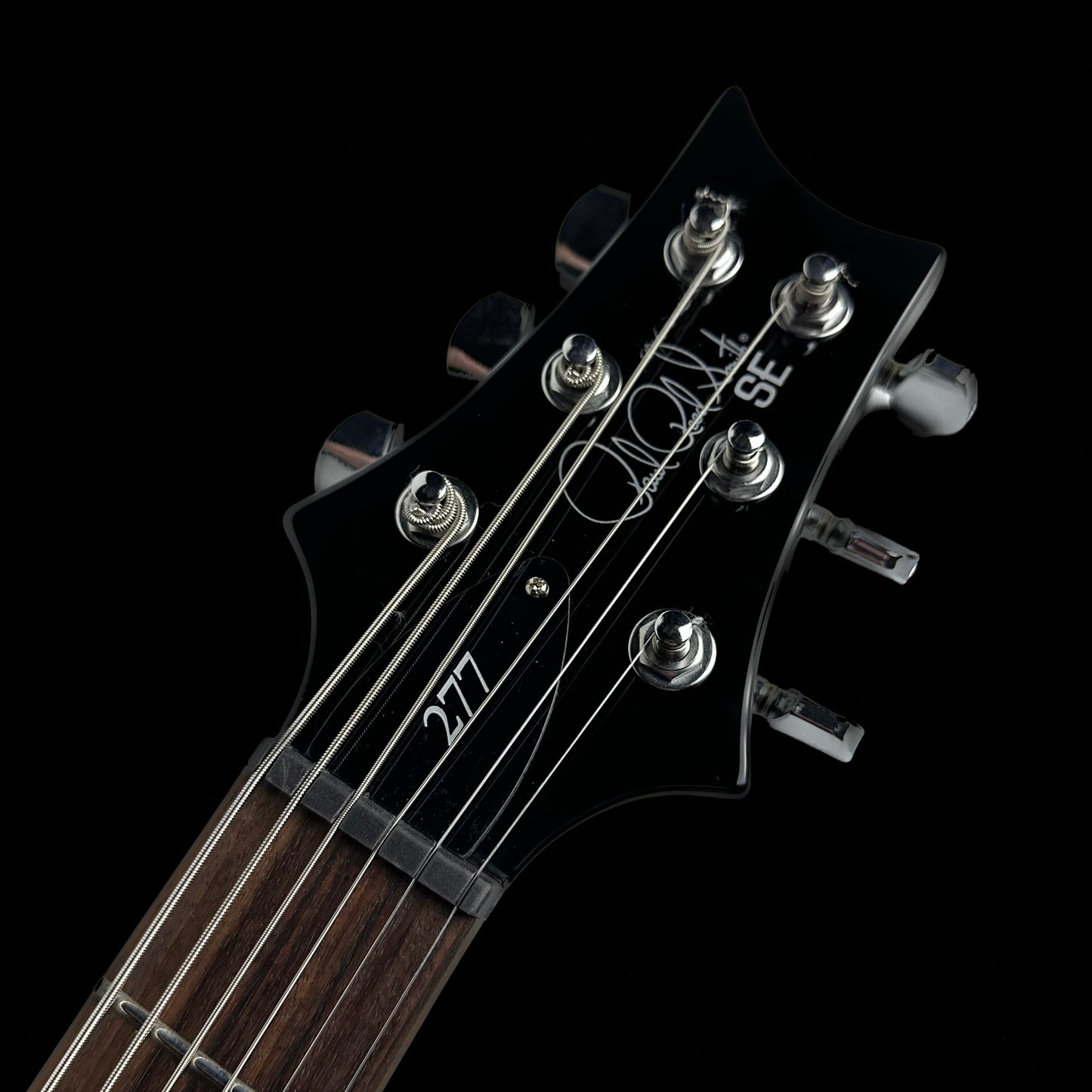 Close up of headstock of PRS Paul Reed Smith SE 277 Baritone Charcoal Burst.