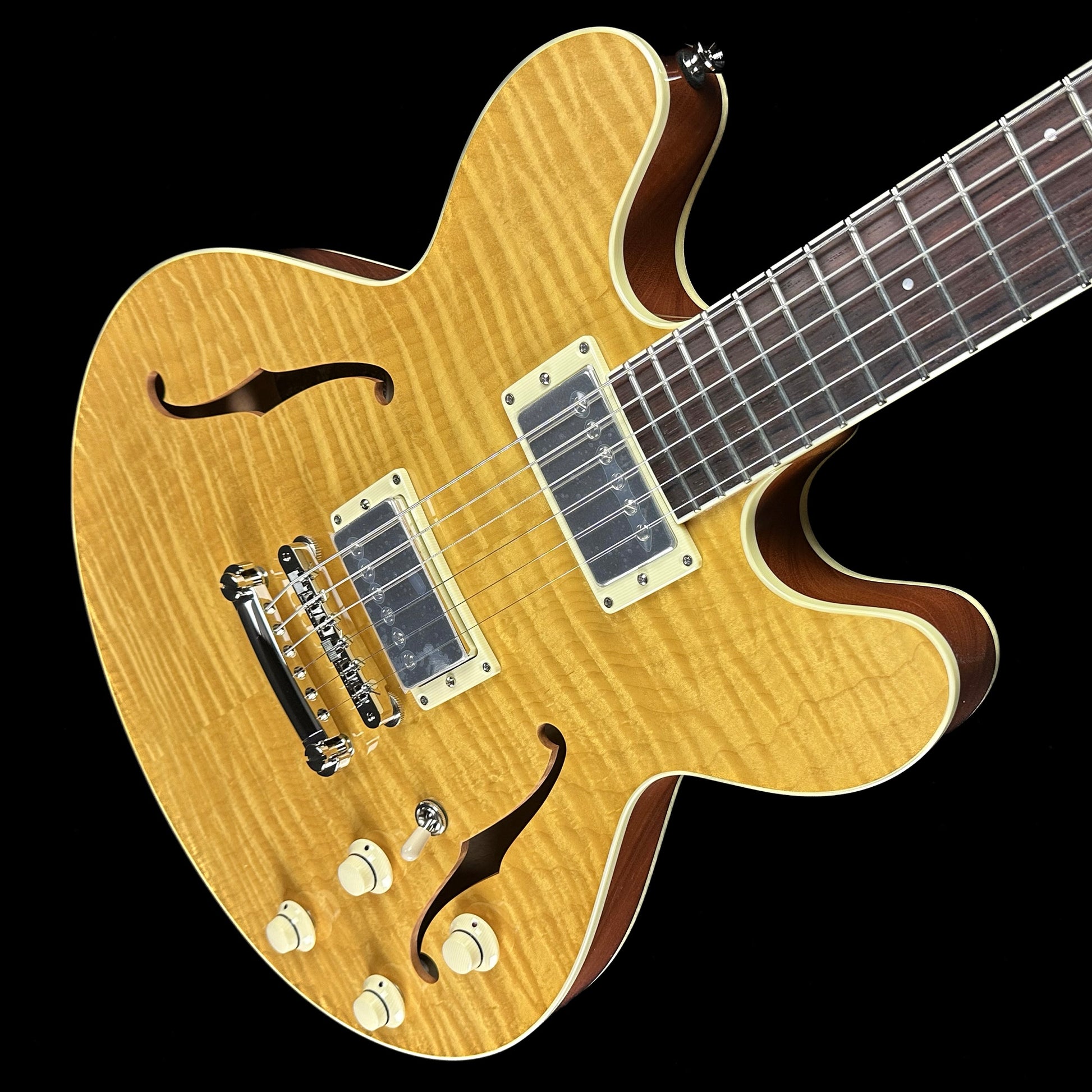 Top down angle of Collings I-35 Deluxe Blonde Flame Top ThroBaks.