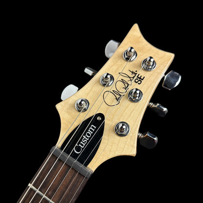 Close up of PRS Paul Reed Smith SE Custom 22 Semi-Hollow Santana Yellow headstock.