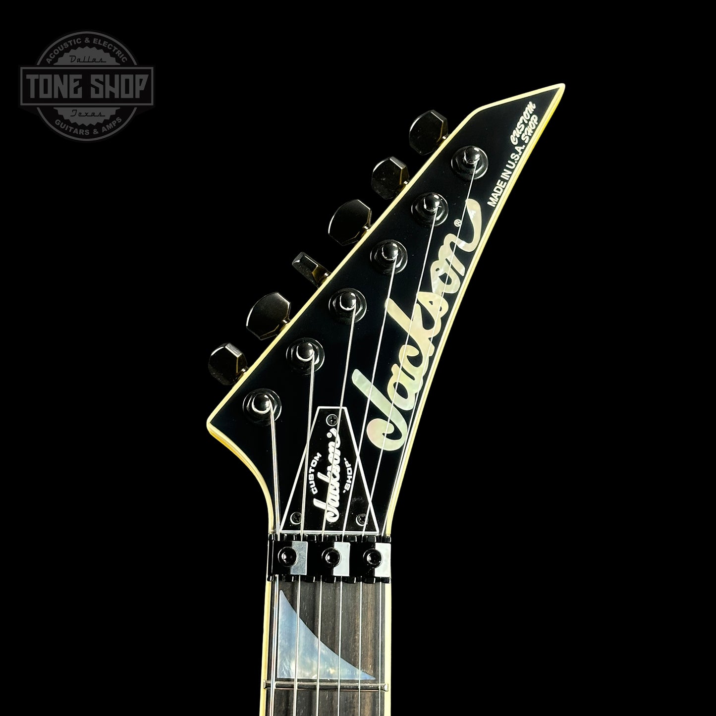 Front of headstock of Jackson Custom Shop SL HSS Floyd Rose Graf Yellow.