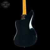 Black electric guitar with a yellow pickguard on a black background, featuring the Fender logo.