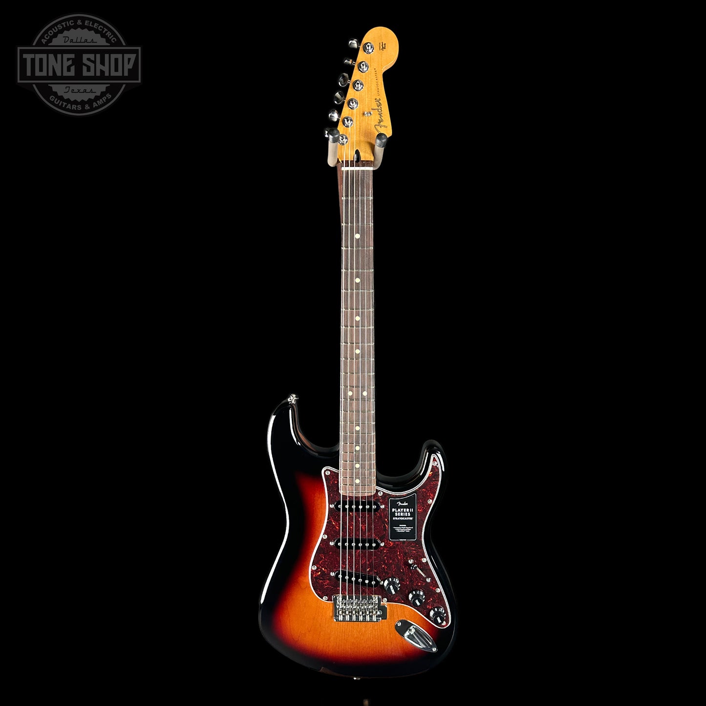 Electric guitar with a sunburst finish on a black background, featuring the Tone Shop logo.