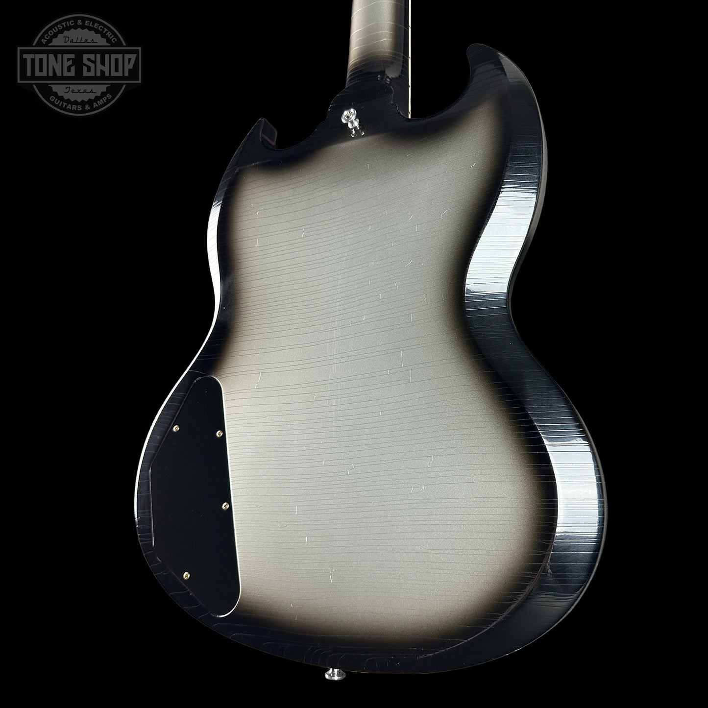 Guitar body with a brushed metal finish on a black background, featuring the Tone Shop logo.
