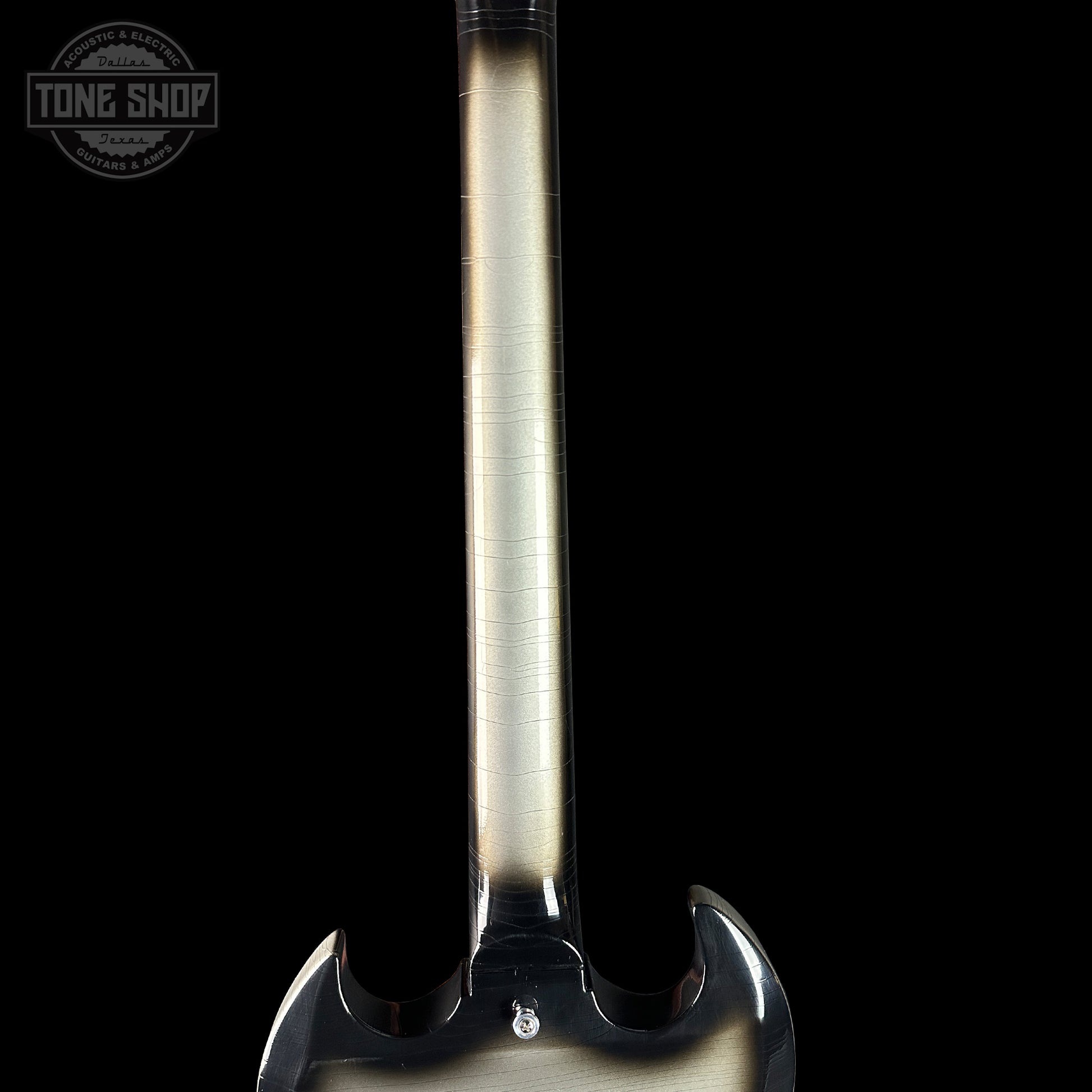 Close-up of a guitar neck with a black background and 'Tone Shop' logo.