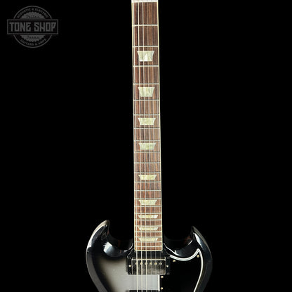 Electric guitar with a black and white design on a black background, featuring the Tone Shop logo.
