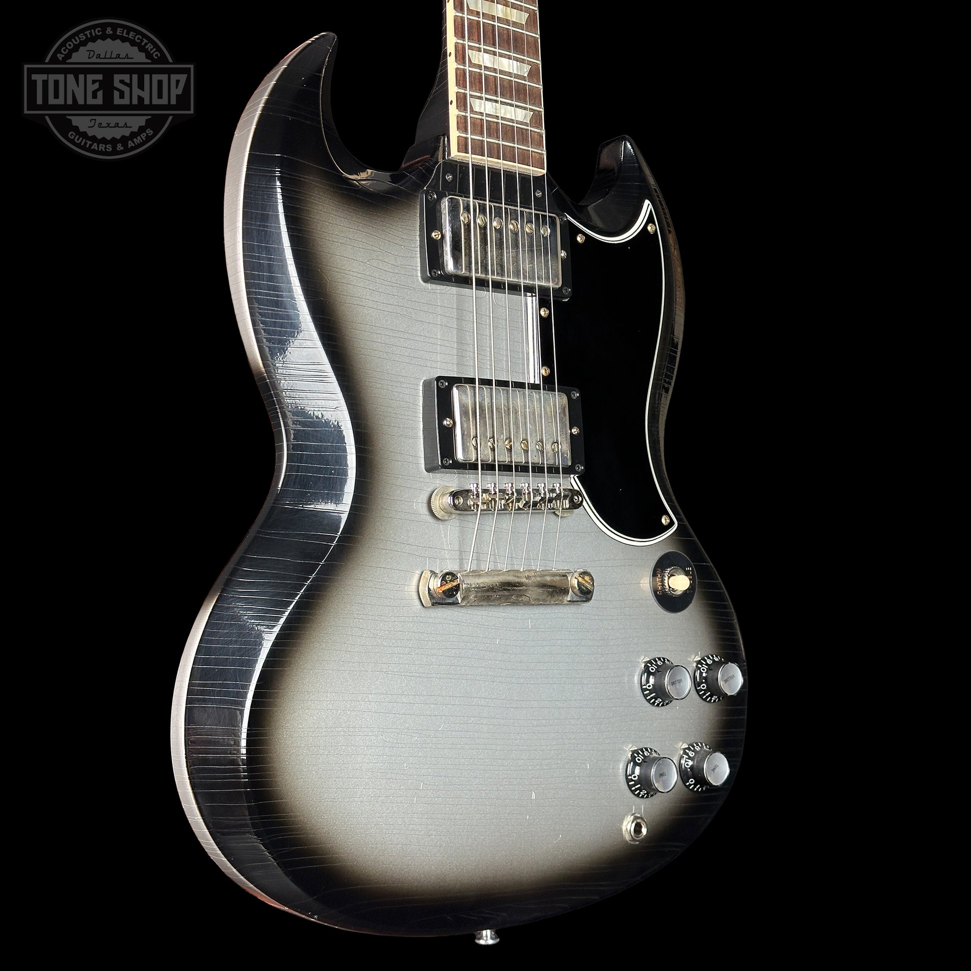 Silver electric guitar on a black background with 'Tone Shop' logo.