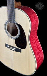 Acoustic guitar with red and white design on a black background