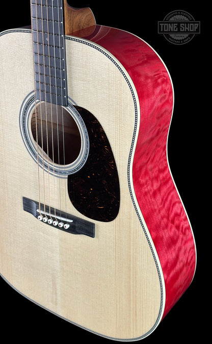 Acoustic guitar with red and white design on a black background