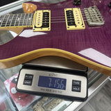 Used 2019 PRS Paul Reed Smith Custom 24 SE Purple No Trem Bar on scale displaying weight.