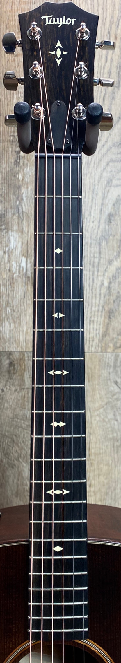 Close up of Taylor Builder's Edition 517e Grand Pacific V-Class Bracing Western Honeyburst fretboard and headstock.