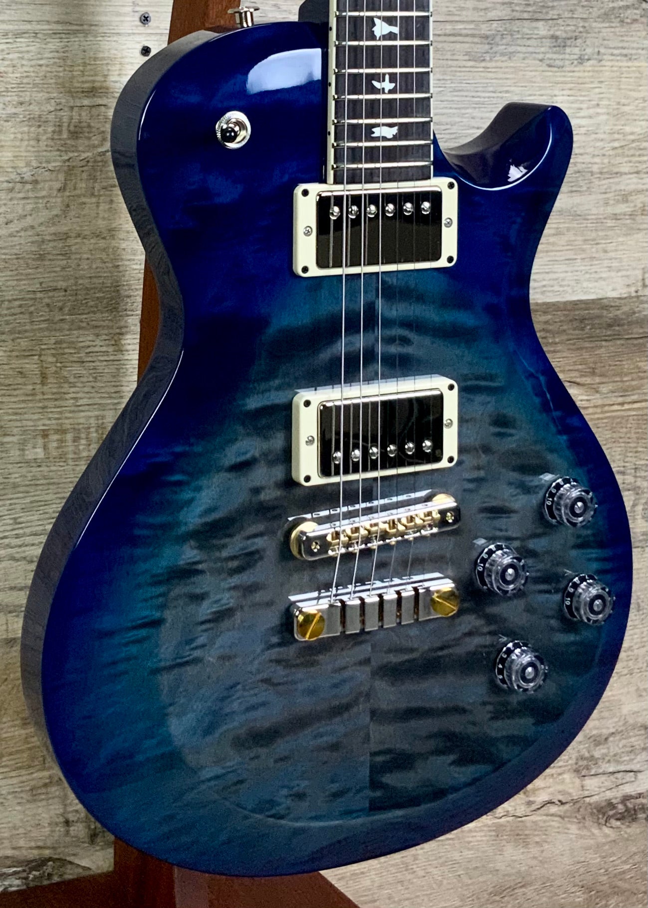 Front left angle of PRS Paul Reed Smith S2 McCarty 594 Singlecut Quilt Faded Gray Black Blue Burst body.