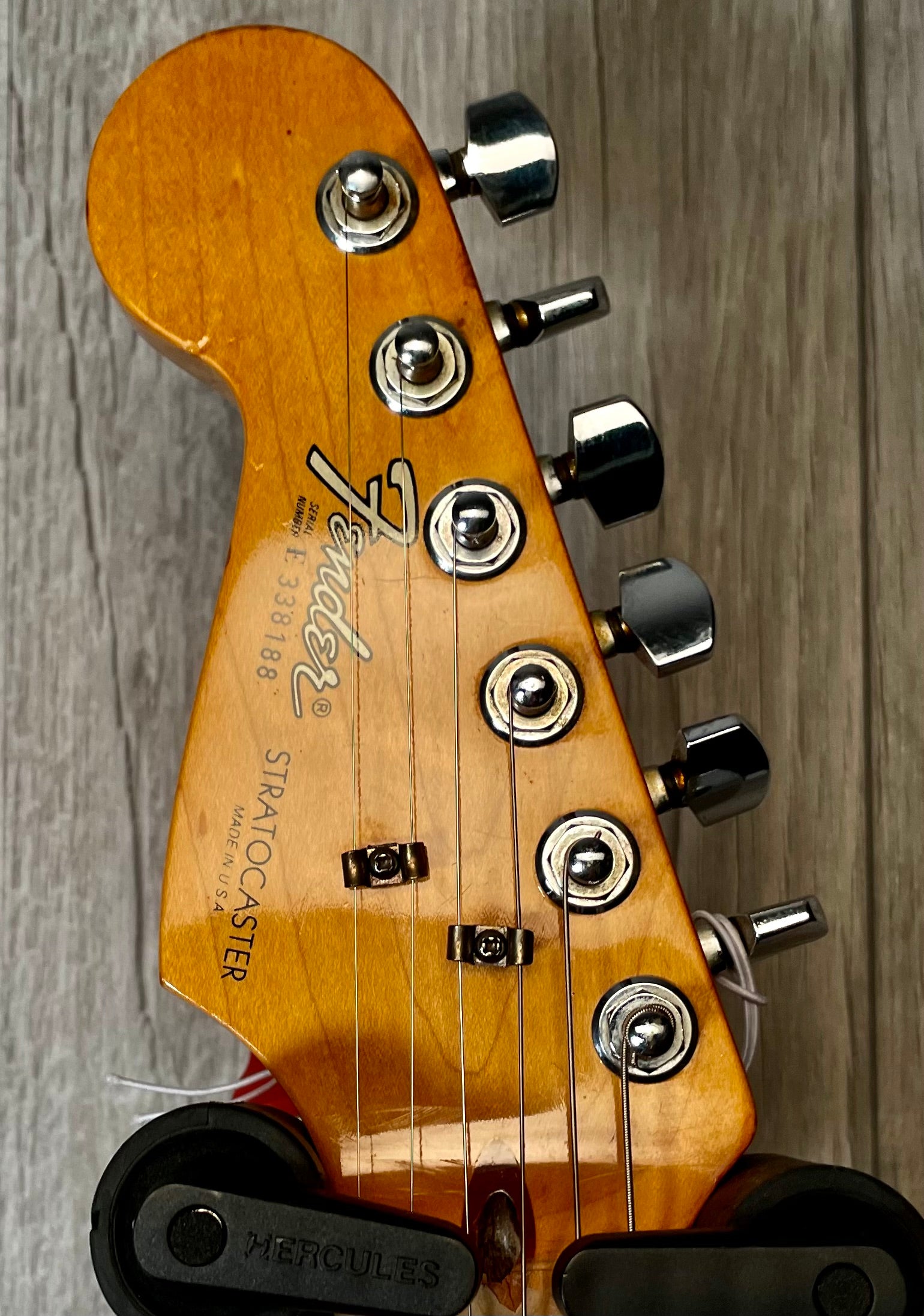 Closeup of Used Vintage 1983 Fender Left Hand Stratocaster 3 Tone Sunburst TSS869 headstock.