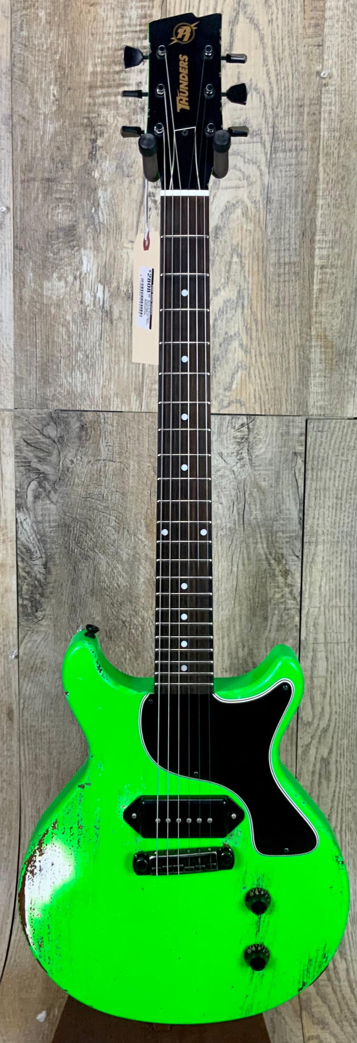 Full frontal of Rock N Roll Relics Thunders DC Neon Green Med Relic.