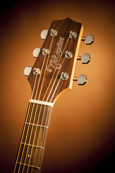 Close up of Takamine GD30CE Natural headstock.
