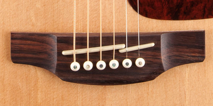 Close up of Takamine GD93CE Dreadnaught Cutaway body and bottom of strings.