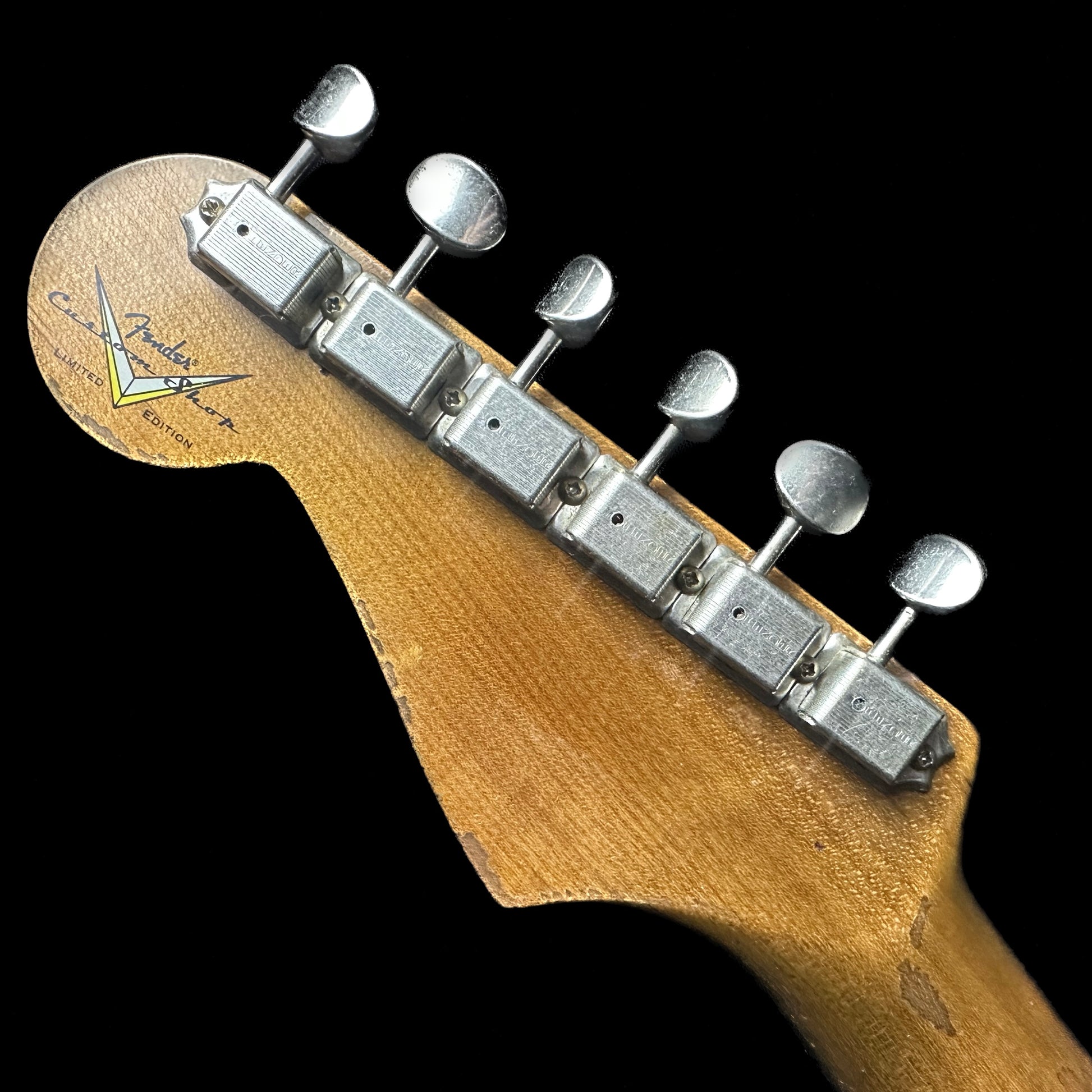 Back of headstock of Fender Custom Shop Limited Edition Poblano Stratocaster Super Heavy Relic Aged Black.