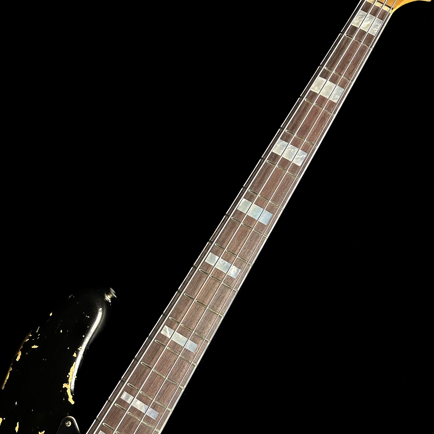 Closeup of Fender Custom Shop Limited Edition Custom Jazz Bass Heavy Relic Aged Black fretboard.