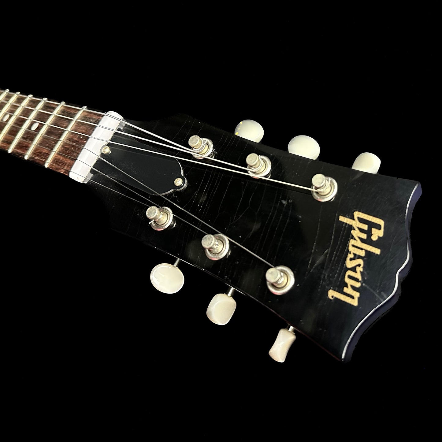 Closeup of Gibson Custom Shop M2M 63 SG Junior Blue Sparkle w/Stinger Short Maestro Murphy Lab Ultra Light Aged headstock.